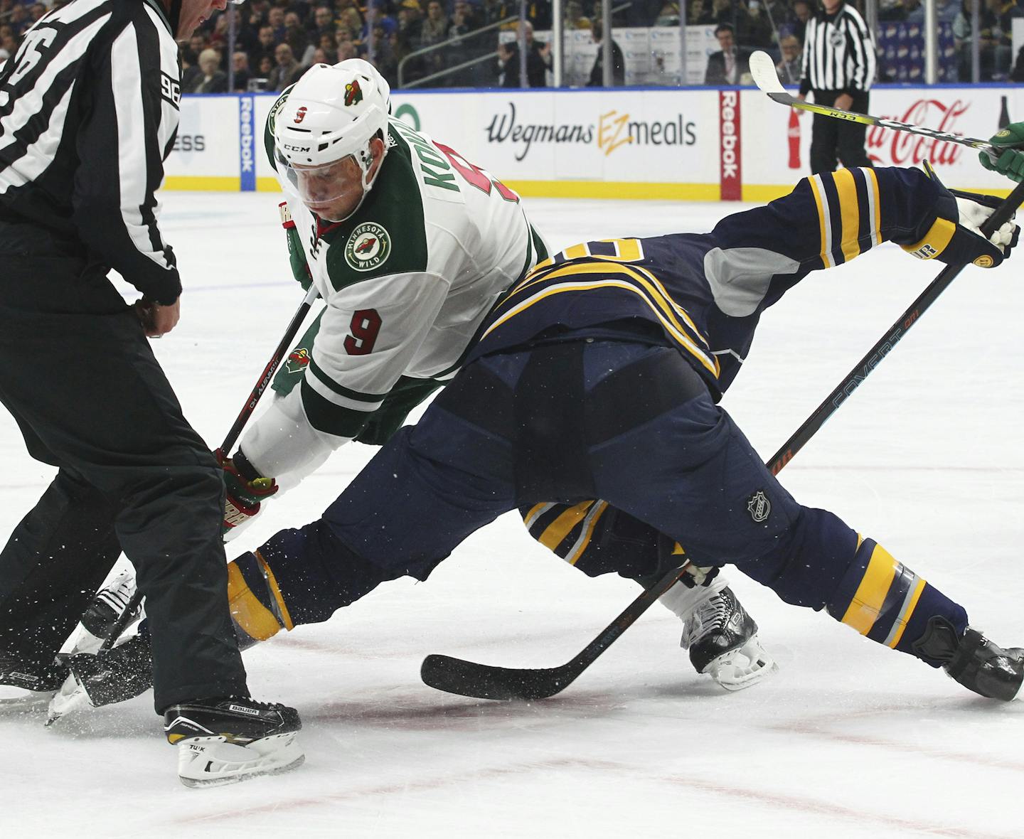 Minnesota Wild's Mikko Koivu (9) takes a draw during the first period of an NHL hockey game against the Buffalo Sabres, Thursday, Oct. 27, 2016, in Buffalo, N.Y. (AP Photo/Jeffrey T. Barnes)