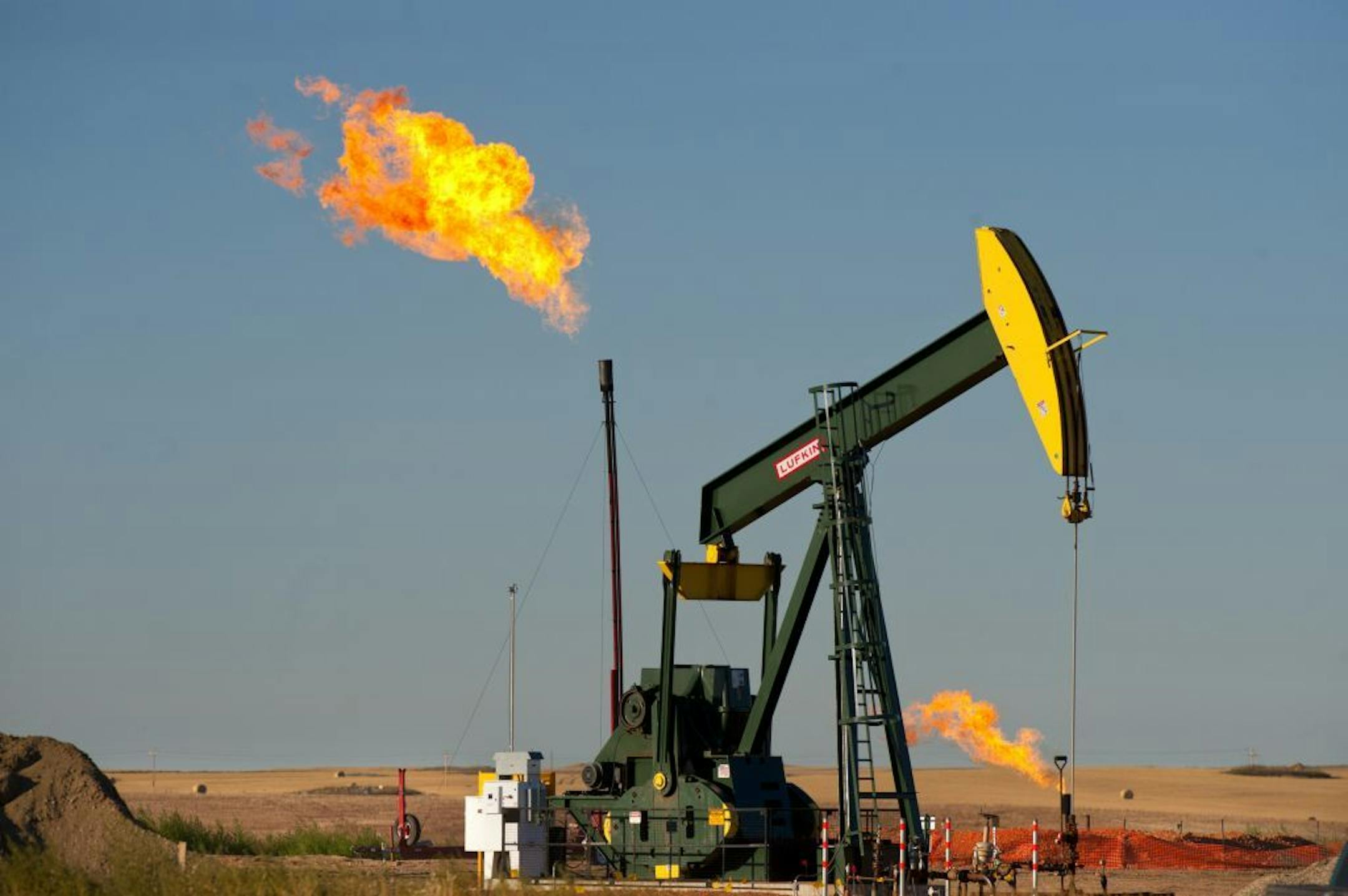 Natural gas is burned off at an oil well east of Williston, North Dakota. Until pipelines are completed gas has to be burned instead of gathered for sale and distribution