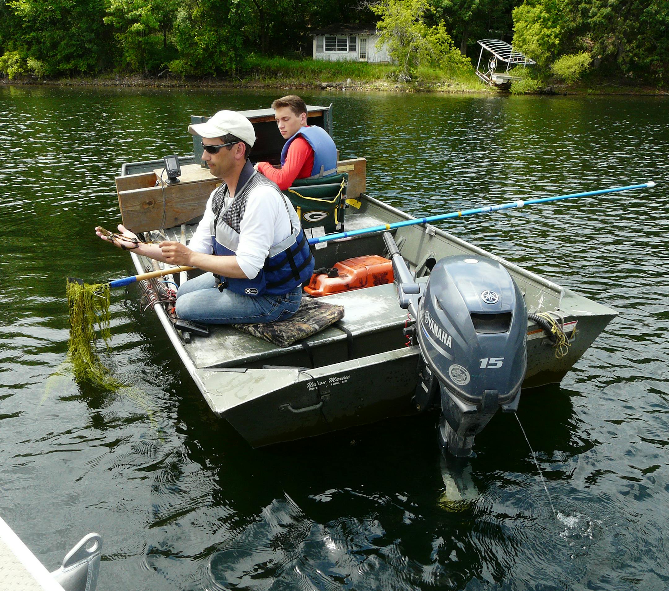 Matt Berg, a biologist with Endangered Resource Services, St. Croix Falls, and his son Mitchell surveyed plant species on Long Lake, in Washington County.