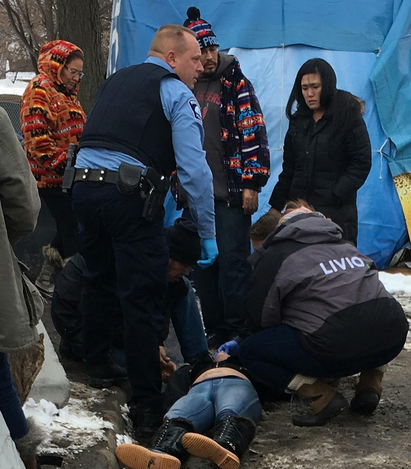 Nearby residents and police respond to a drug overdose Wednesday afternoon at the large homeless encampment along Hiawatha and Franklin Avenues. The woman was revived with four injections of Narcan, a drug that reverses the effects of heroin. It was the fourth overdose at the camp in a 24-hour period.