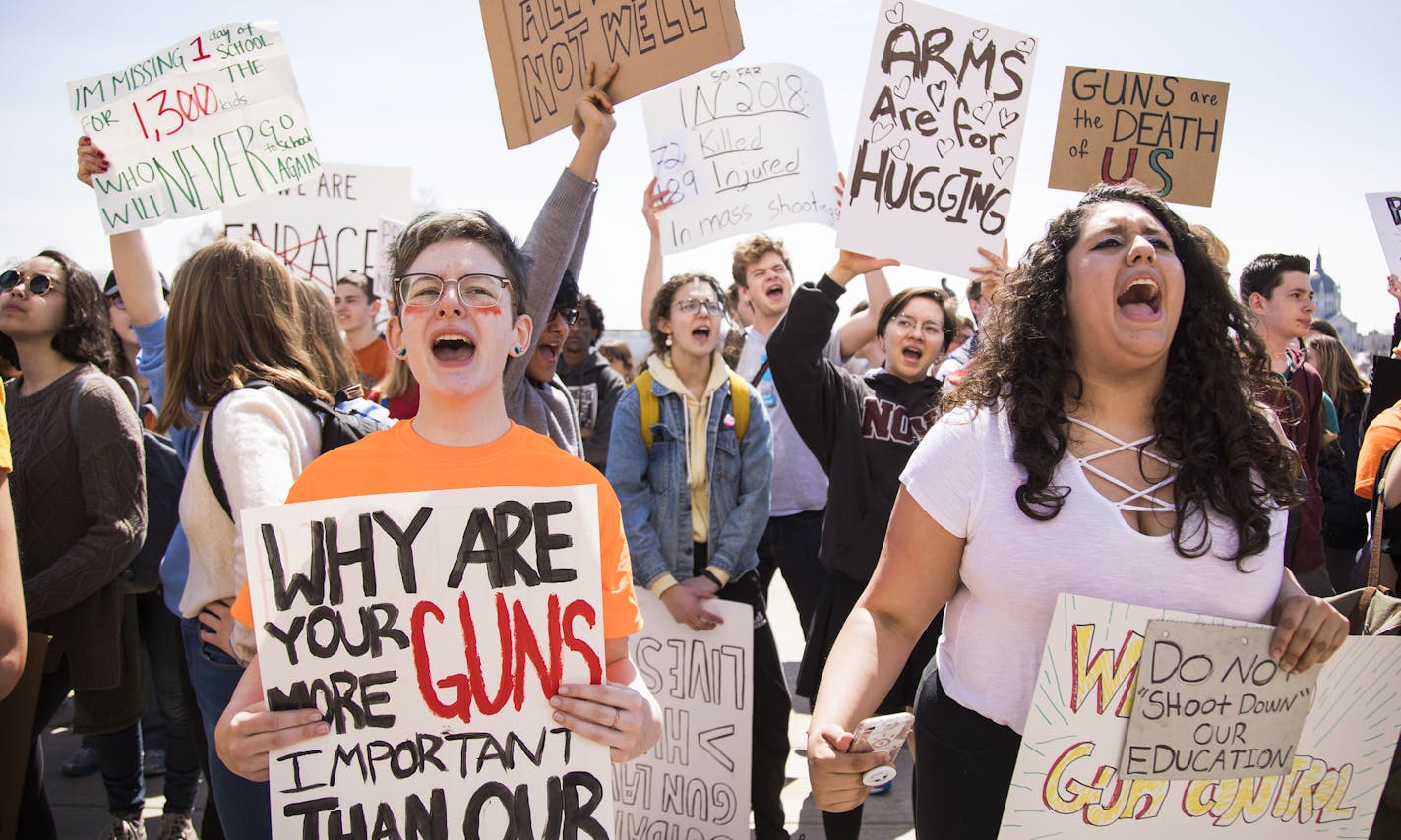 Emory Solomonson, right, a senior at Wayzata High School, and Jasmine Kelly, a freshman at Performing Institute of Minnesota Arts High School in Eden Prairie chant during the rally. ] LEILA NAVIDI &#xef; leila.navidi@startribune.com BACKGROUND INFORMATION: Students from around the Twin Cities Metro area rally at the State Capitol to protest against gun violence in St. Paul on Friday, April 20, 2018.