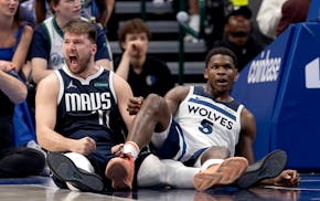 Luka Doncic (77) of the Mavericks reacts after Anthony Edwards of the Timberwolves is called for an offensive foul tonight in Dallas.