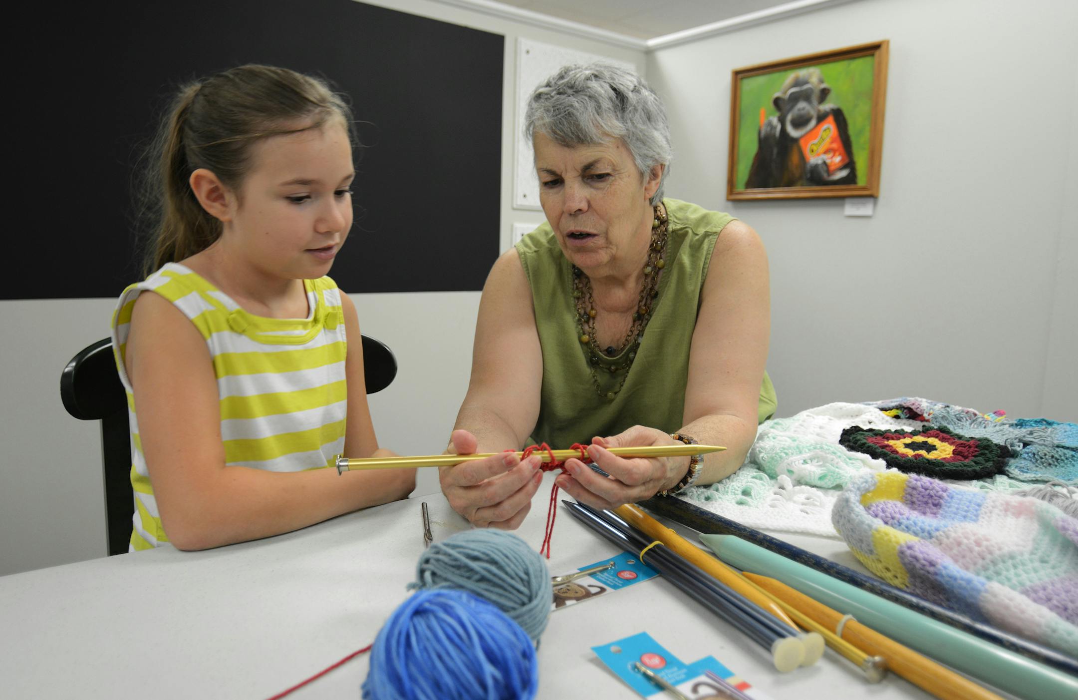 Katie Boras, 9, and Sue Fenlon, of Hastings, worked on a yarn craft during the opening weekend of the BreakAway Arts Center in Hastings. Photo by Liz Rolfsmeier, Special to the Star Tribune