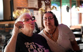 Darlene Rasmussen, left, a customer of over 35 years, and Donna Hatton, a customer of 20 years, blew bubbles during their friend Peggy's 69th birthday