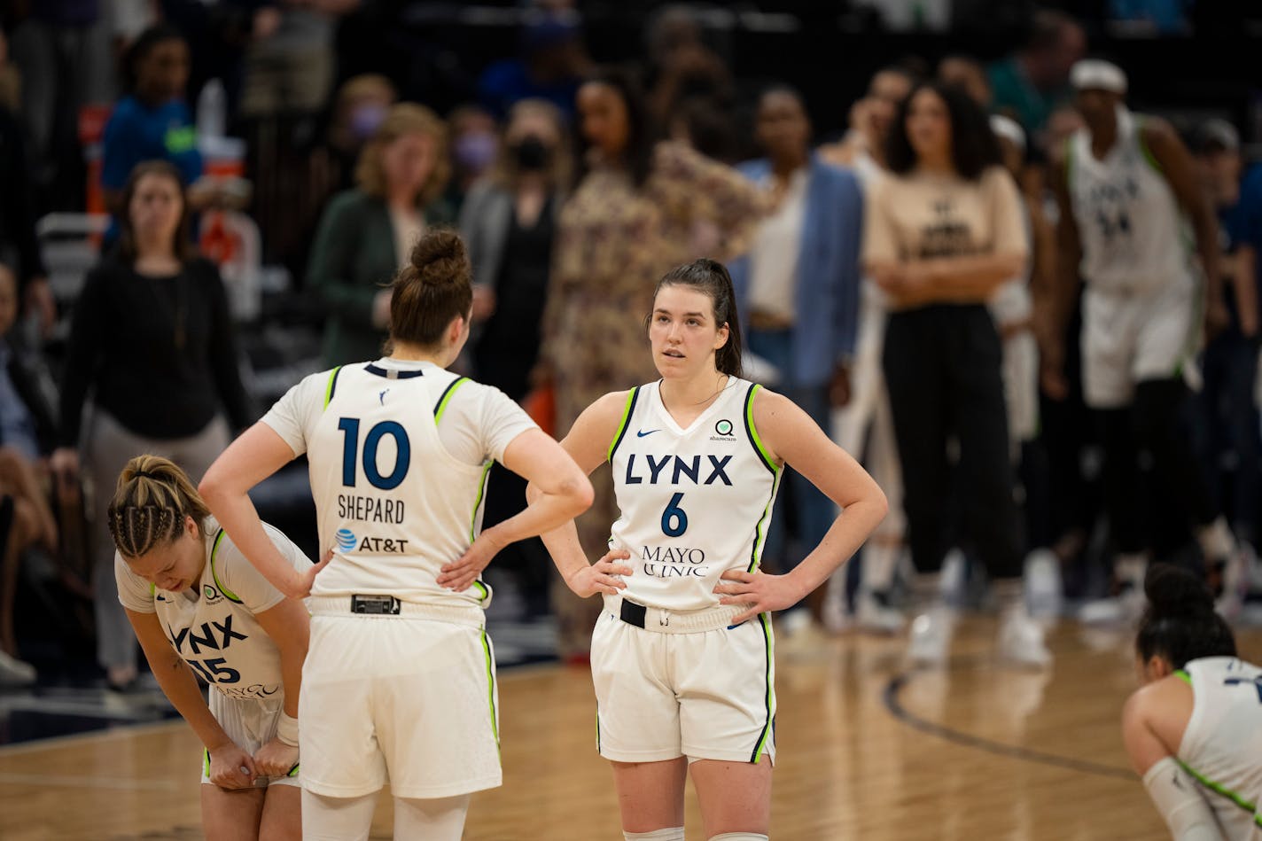 Lynx players Rachel Banham (15), Jessica Shepard (10), Bridget Carleton (6), and Kayla McBride (21) waited out the end of a game May 29 at Target Center