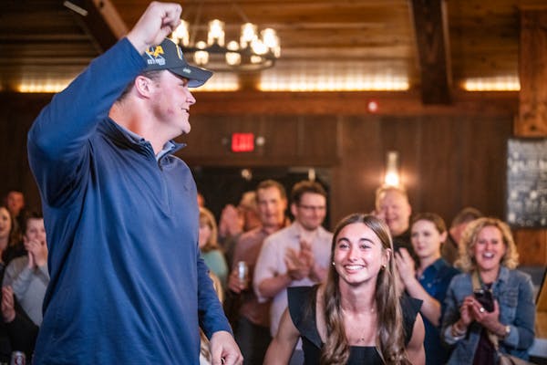 Joe Alt celebrates with girlfriend Emilie Meyer at 7 Vines Vineyard and Winery in Dellwood after being picked fifth overall by the Los Angeles Charger