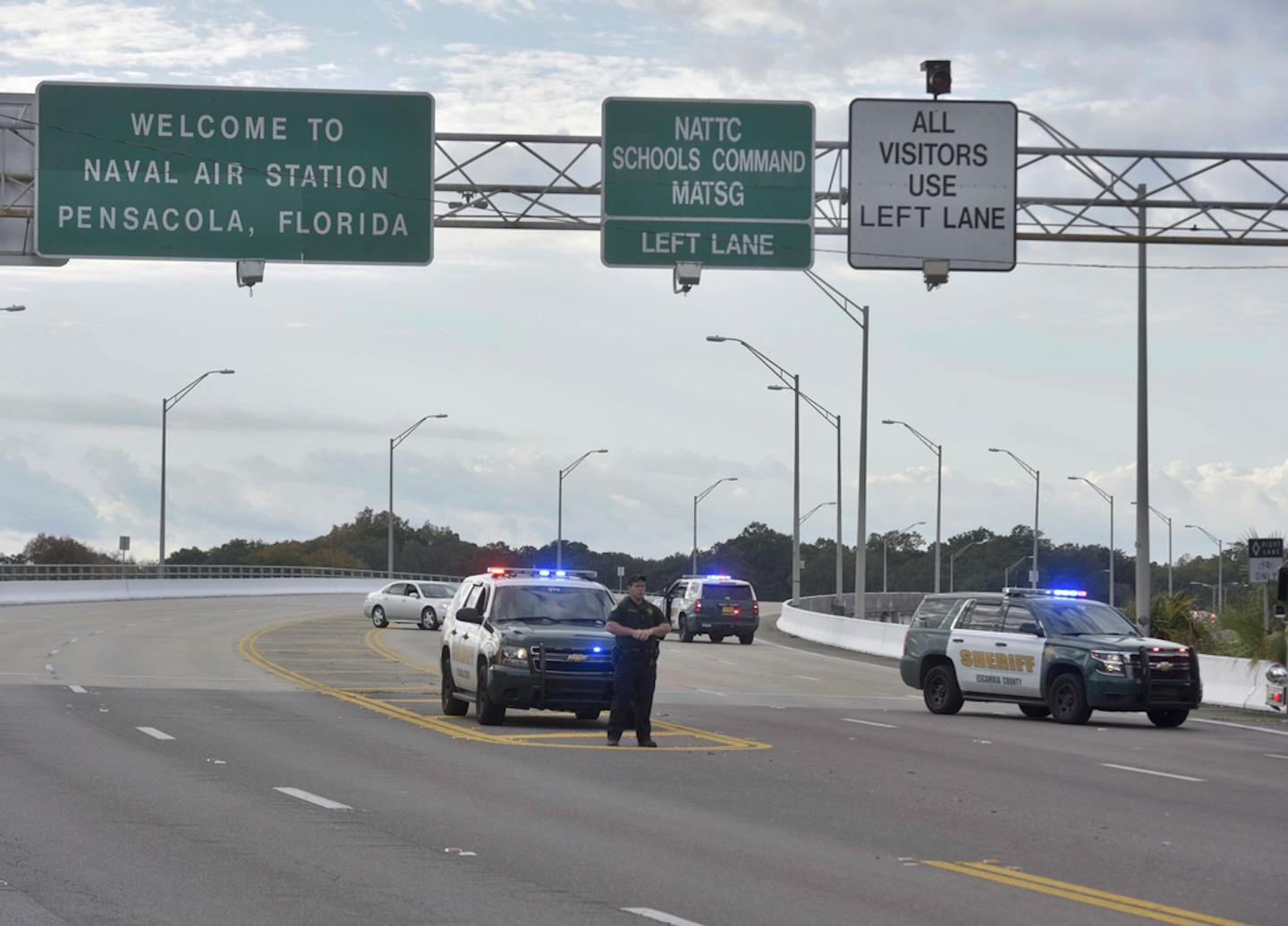 Police vehicles block the entrance to the Pensacola Air Base, Friday, Dec. 6, 2019 in Pensacola, Fla. The US Navy is confirming that a shooter is dead and several injured after gunfire at the Naval Air Station in Pensacola.