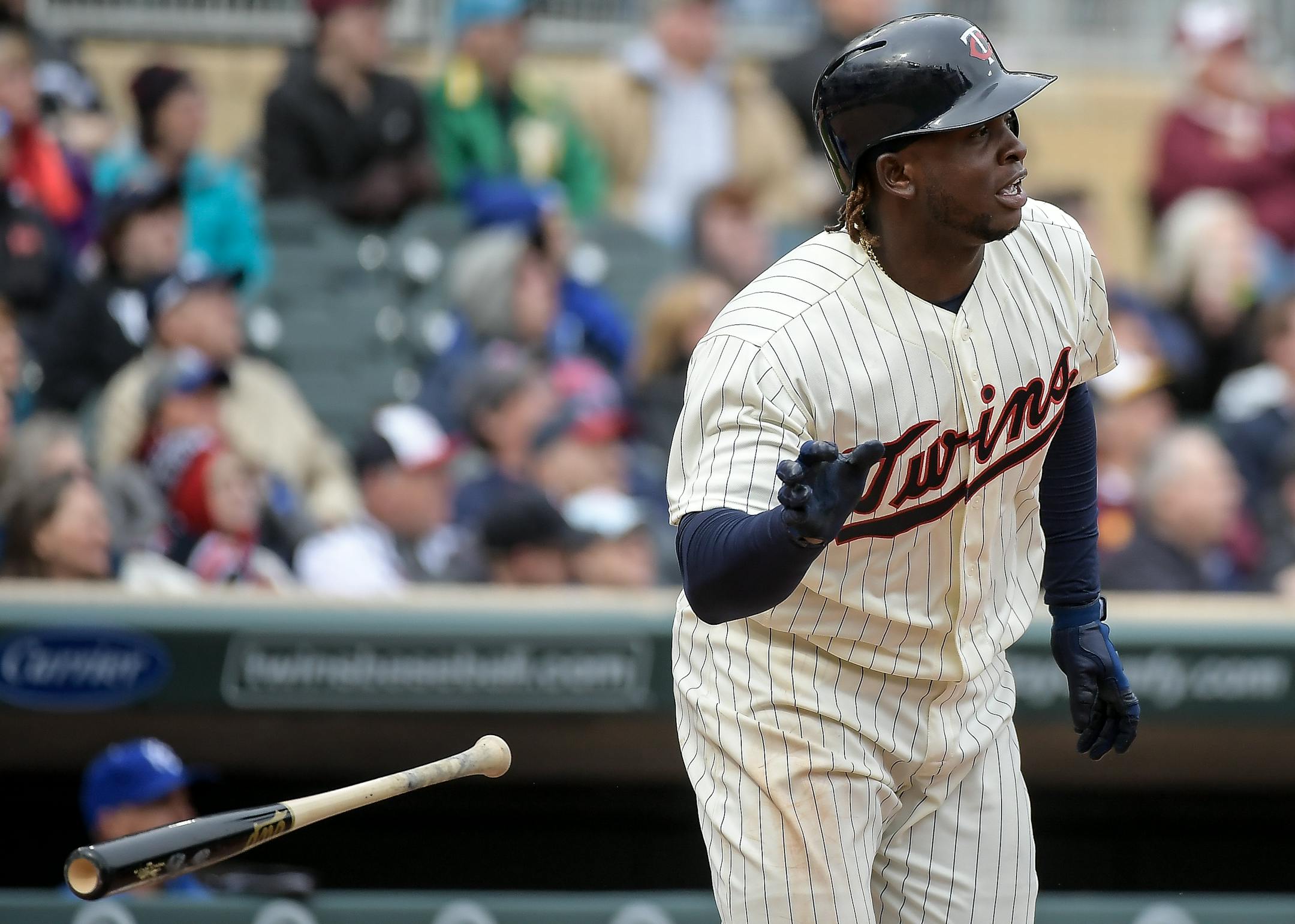 Minnesota Twins third baseman Miguel Sano (22) tossed his bat after hitting a triple, bringing home Brian Dozier, Max Kepler and Joe Mauer