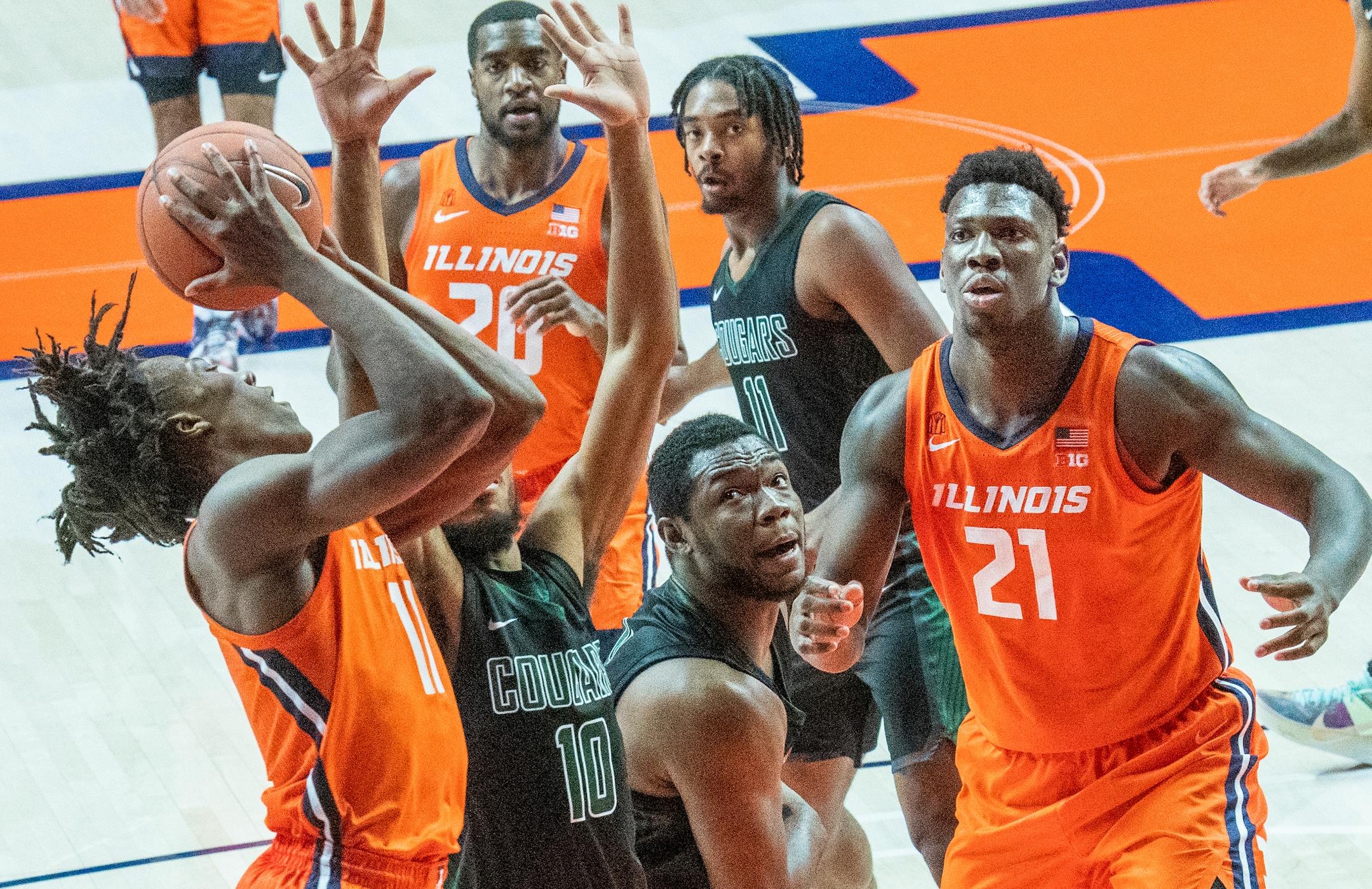 Illinois guard Ayo Dosunmu (11) shoots as Chicago State's forward Carlo Marble (10) defends during the second half