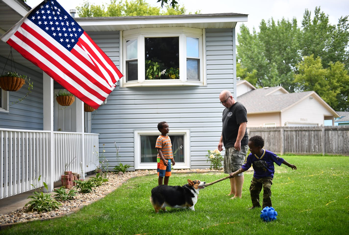 Chad Donovan watched as two neighbor boys, ages 6 and 4, played with his dog, Tesla, at his Rochester home. He was in the third planeload of Americans to arrive in Saudi Arabia for Desert Shield in 1990.