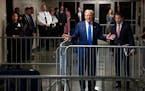 Former President Donald Trump stops to speak to reporters in the corridor as he arrives for his criminal trial in Manhattan on Friday morning, May 3, 