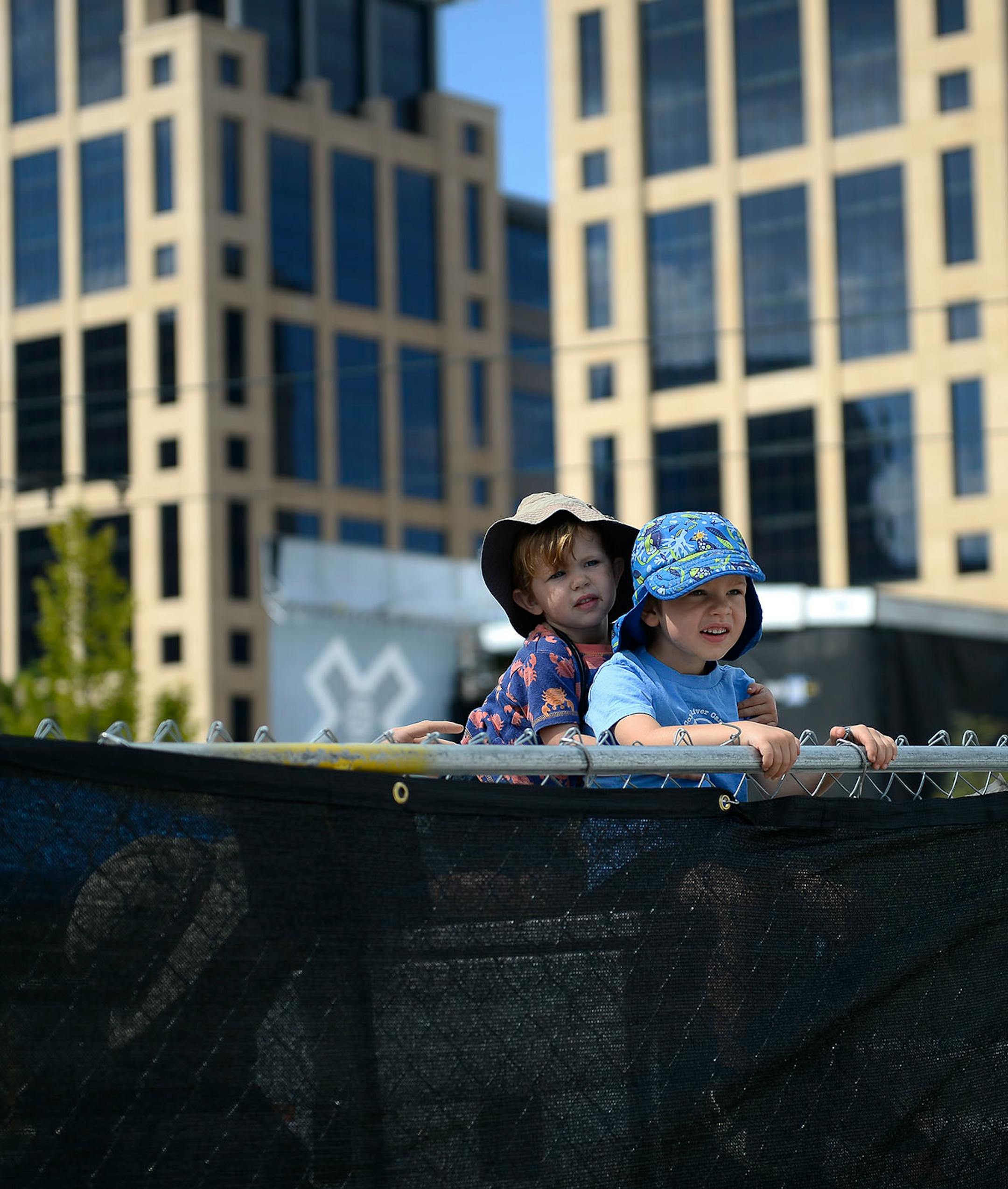 Emmett Huston, 4, right, and younger brother Morgan, 2, found a vantage point of X Fest happenings on top of a utility box with the help of their father.