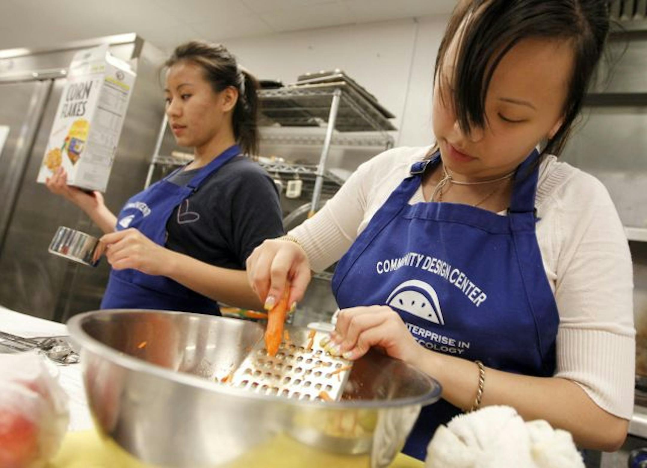 Xia Lee grated carrots for her Minnesota coleslaw.