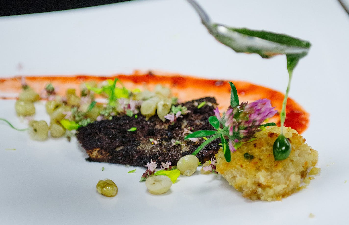 Credit: Becca Dilley for the heavy table. Sean Sherman, who calls himself the Sioux Chef, prepping a dish.