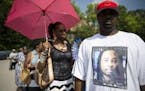 Mourner Bill Smith wears a shirt bearing the likeness of Samuel DuBose as he waits on line outside funeral services for Dubose at the Church of the Li