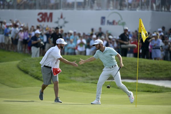 Matthew Wolff celebrated with his caddie after winning the 3M Open at TPC Twin Cities.