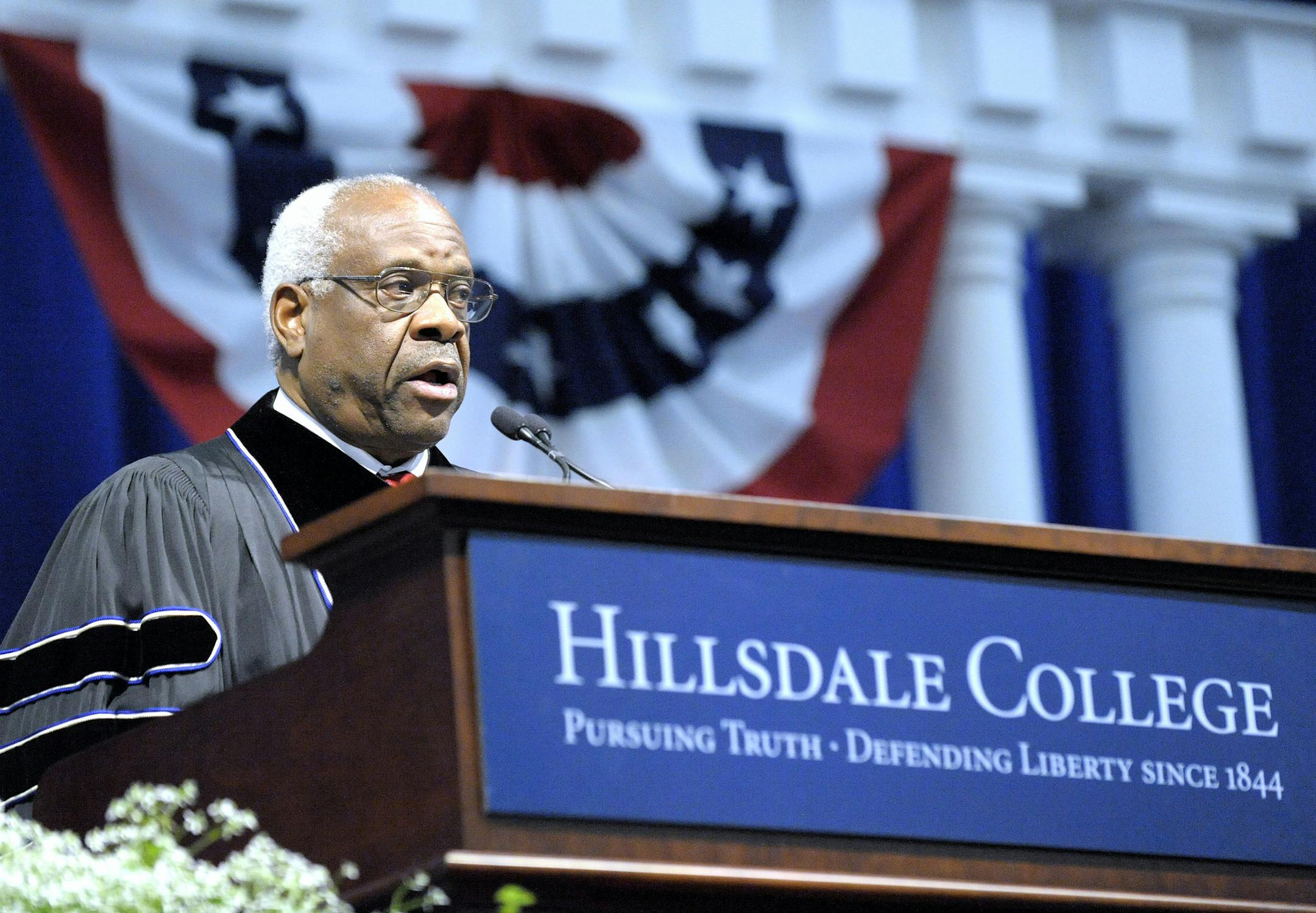 In a Saturday, May 14, 2016 photo, U.S. Supreme Court Associate Justice Clarence Thomas delivers the commencement address to the 2016 Hillsdale College graduating class in the Margot V. Biermann Athletic Center, in Hillsdale, Mich. (Todd McInturf, The Detroit News via AP) (Todd McInturf, The Detroit News via AP)