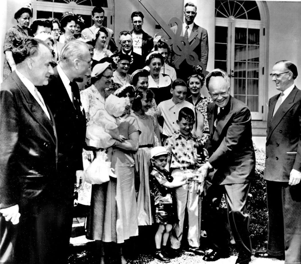 President Eisenhower accepted gifts from youngsters Charles Nagel and Richard Stransky when the whole town of Funkley visited the White House in May 1953. In the foreground are Minnesota Rep. Harold C. Hagen, Sen. Edward Thye and Rep. Walter H. Judd.