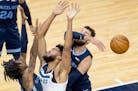Jonas Valanciunas (17) of Memphis Grizzlies blocked a shot by Minnesota Timberwolves Karl-Anthony Towns (32) in the first quarter.