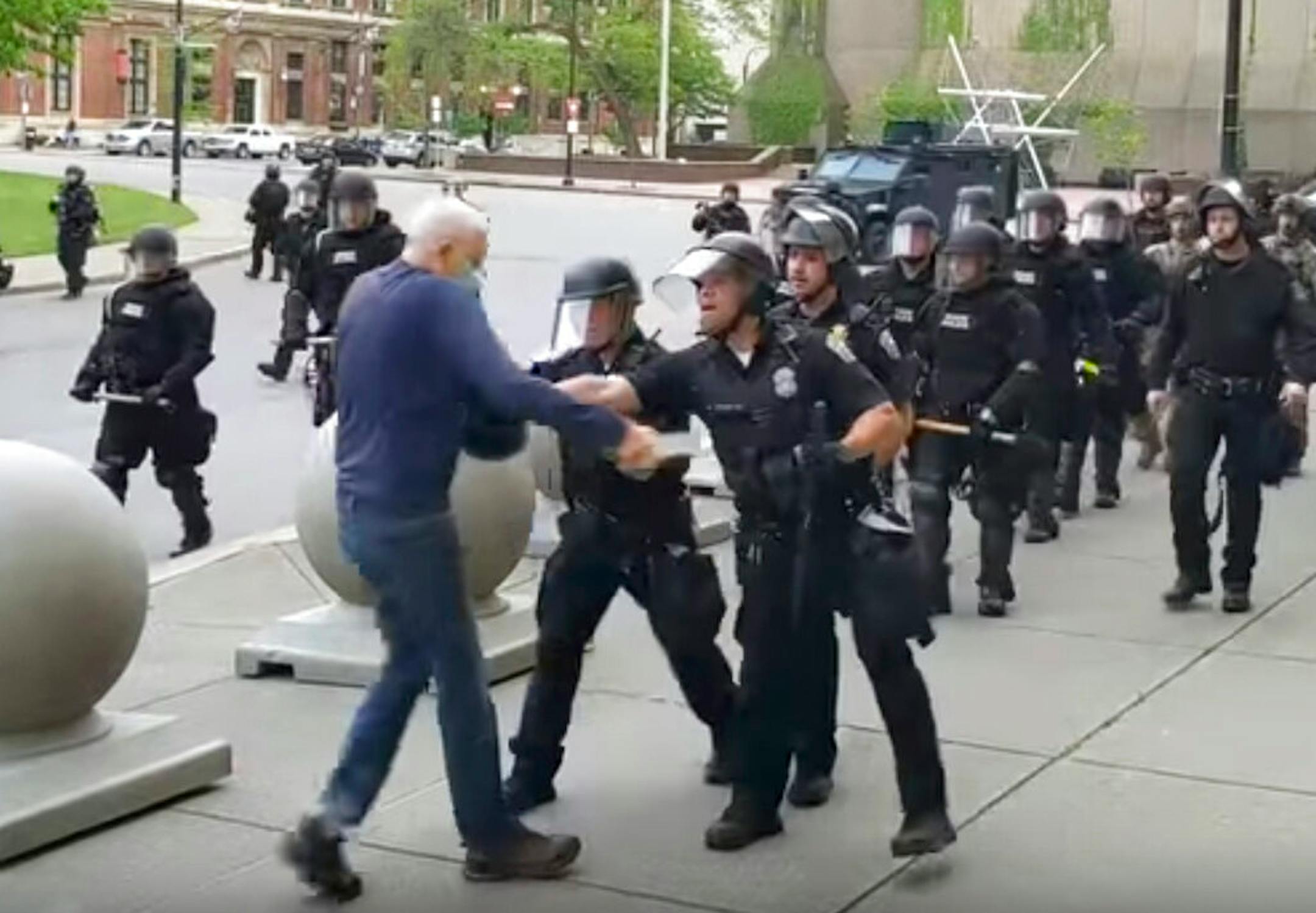 A Buffalo police officer appears to shove a man who walked up to police Thursday, June 4, 2020, in Buffalo, N.Y.