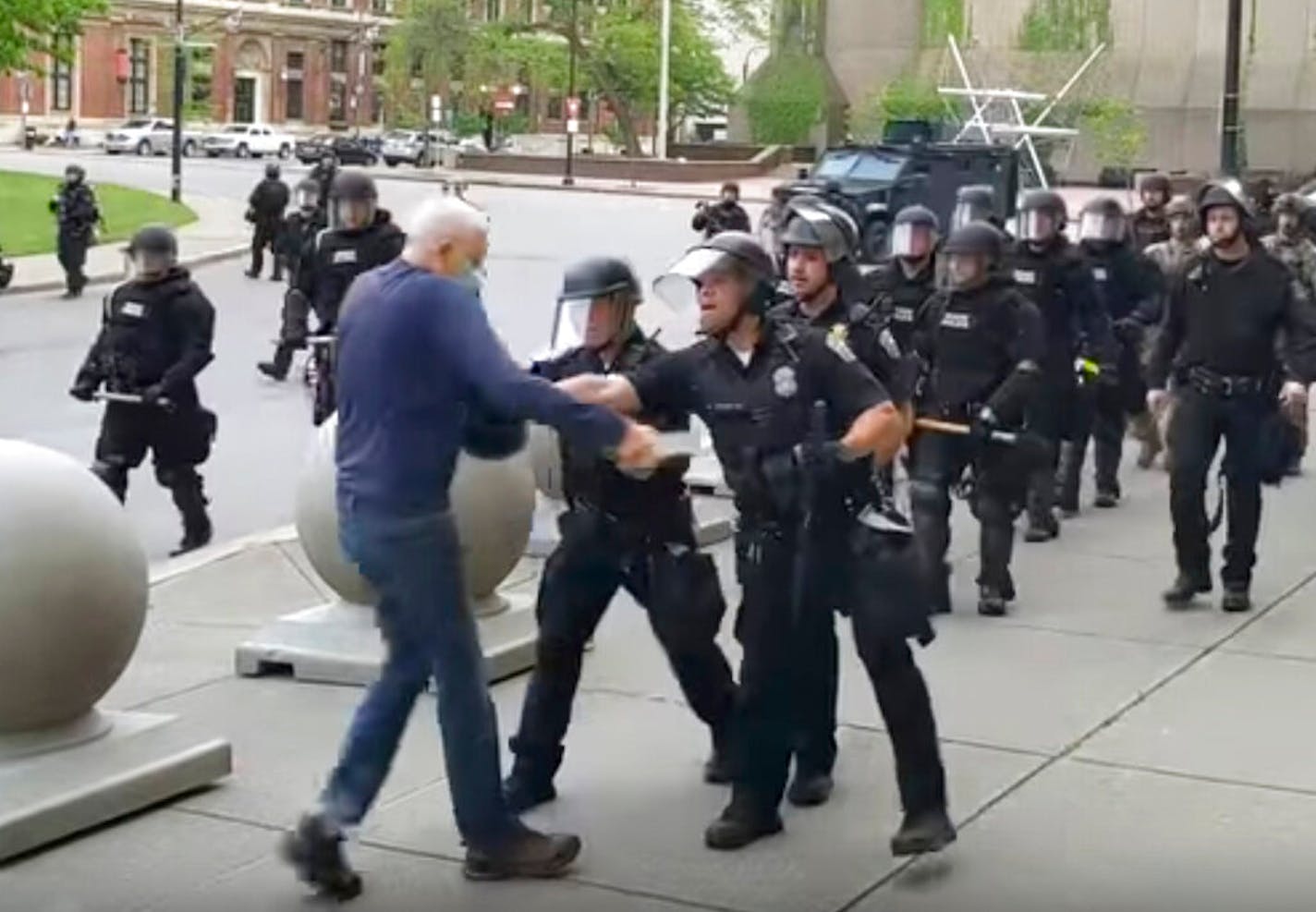 A Buffalo police officer appears to shove a man who walked up to police Thursday, June 4, 2020, in Buffalo, N.Y.