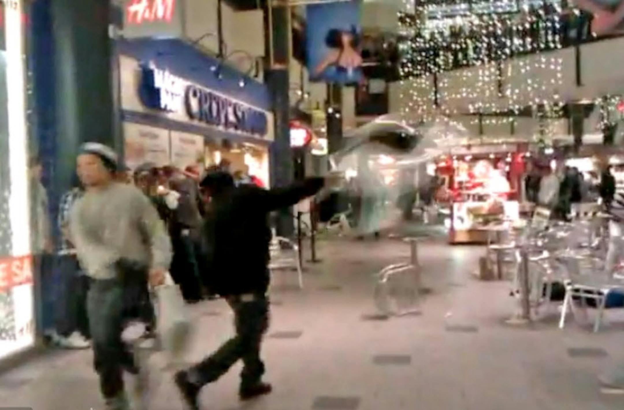 this screen grab from YouTube video shows someone throwing a chair during Monday's melee at Mall of America.