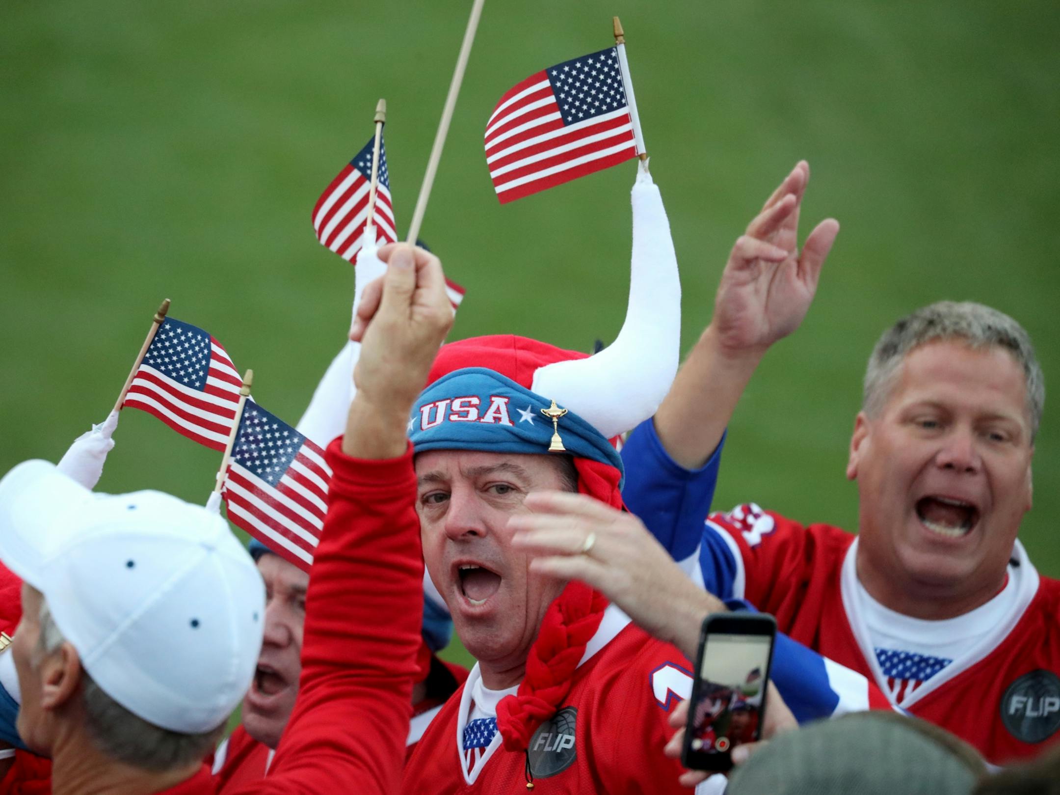 Fans chant U-S-A in the grandstand surrounding the first tee.
