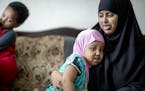 Fardowsa Bashir — seen with her children Anzal Dahir, 3, in her arms, and Sadri, 2, at left — said she has learned to read, cook healthy foods and