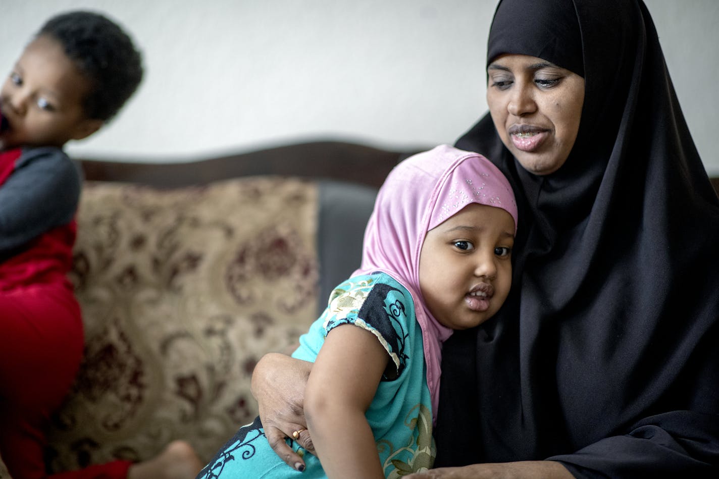 Fardowsa Bashir — seen with her children Anzal Dahir, 3, in her arms, and Sadri, 2, at left — said she has learned to read, cook healthy foods and be a better parent while participating in a University of Minnesota study.