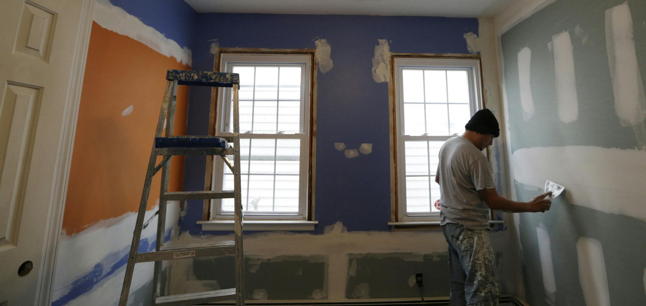 A worker prepares the walls for paint in Ryan and Connor Troy's bedroom in Long Beach, N.Y., Wednesday, Dec. 12, 2012. Renovations to the bungalow style house, severely damaged in Superstorm Sandy, are being paid for by Donald Denihan, who had near-death experiences that convinced him he had a purpose in life, to help others. (AP Photo/Kathy Willens)