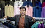 Long Her, a Hmong refugee, voted for Hillary Clinton in 2016, but now he's considering voting for Trump after his business, New Fashions Tailoring & A