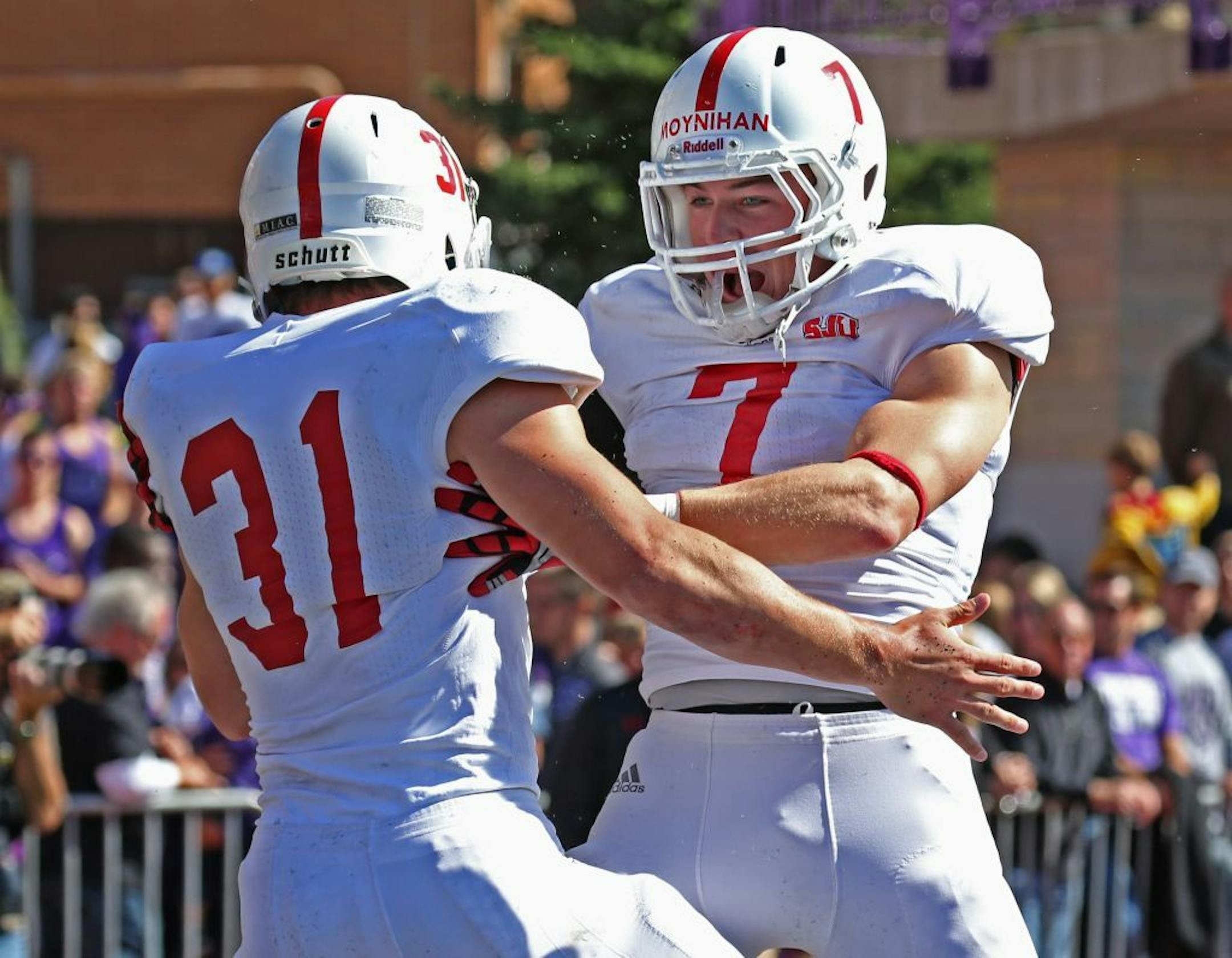 St. Thomas vs. St. Johns, St. Paul, MN., 9/21/13. (left to right) St. John's running back Sam Sura celebrated his touchdown with Colin Moynihan in first half action.