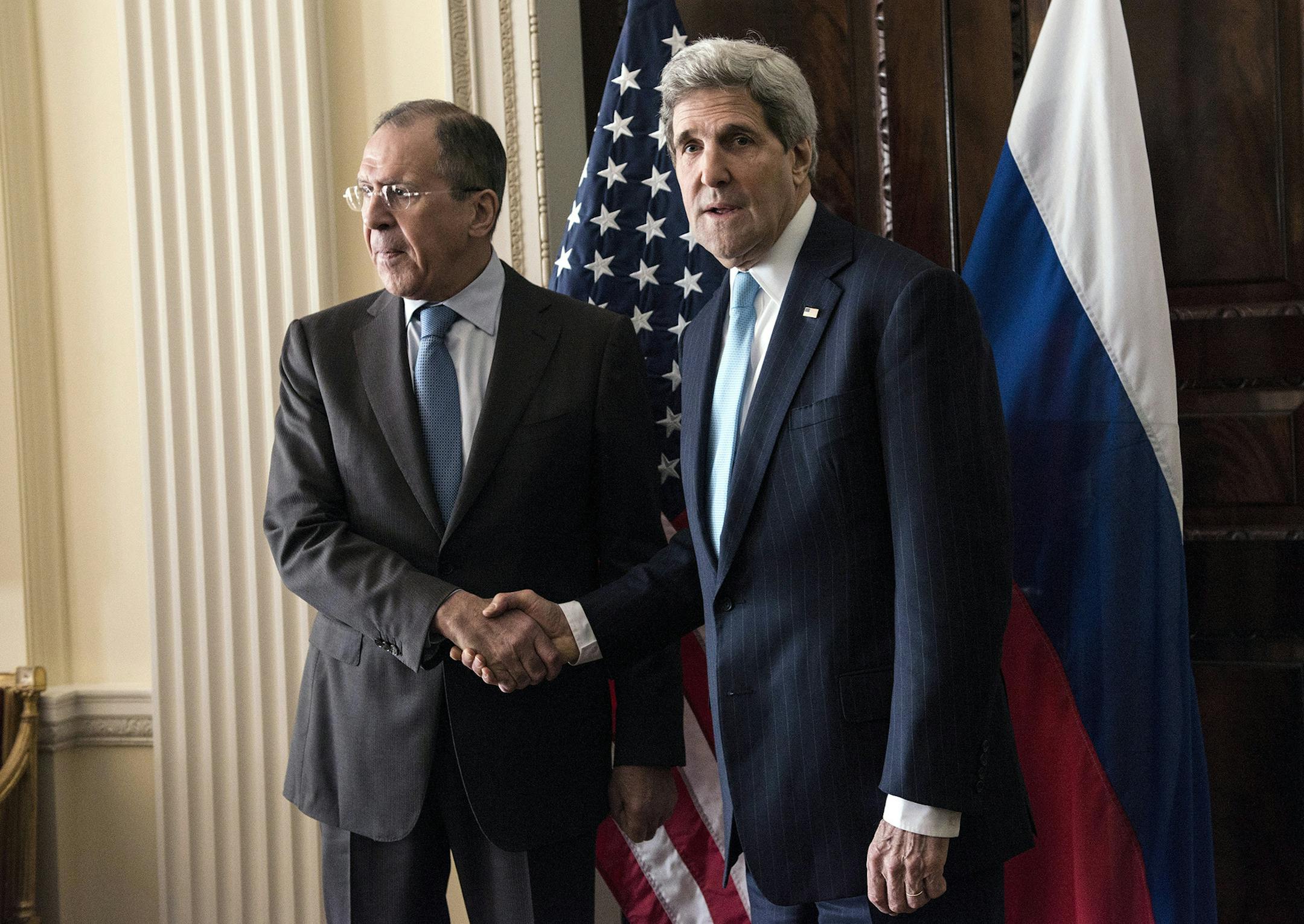 Russian Foreign Minister Sergey Lavrov, left, and US Secretary of State John Kerry shake hands before a meeting at Winfield House in London, Friday March 14, 2014. U.S. Secretary of State John Kerry flew to London on Friday to meet with Russian Foreign Minister Sergey Lavrov in a last-minute bid to stave off a new chapter in the East-West crisis over Ukraine. (AP Photo/Brendan Smialowski, Pool) ORG XMIT: MIN2014031411490846
