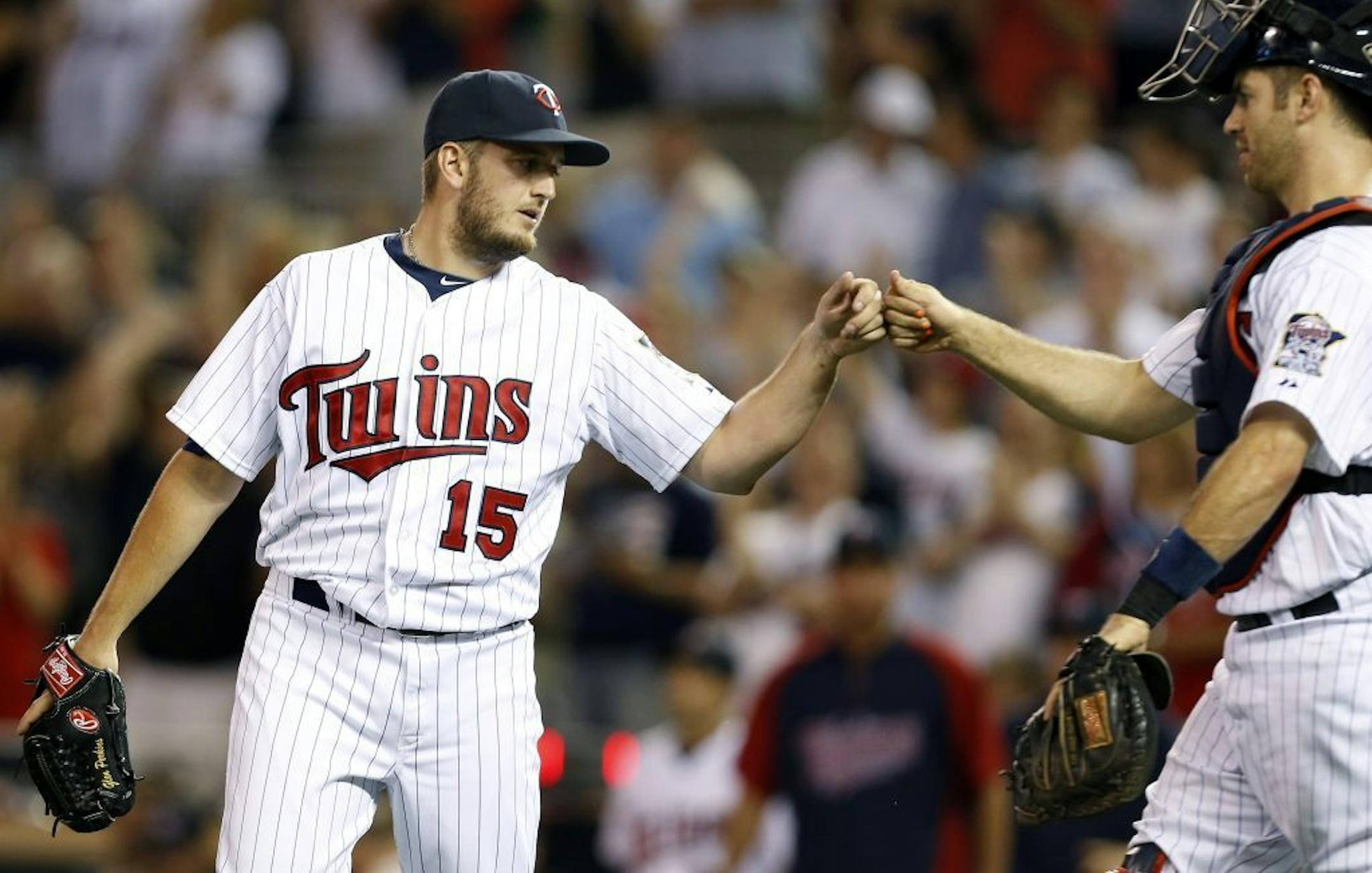 Minnesota Twins pitcher Glen Perkins (15) was congratulated by catcher Joe Mauer (7) after getting the save. Minnesota beat Kansas City by a final score of 3-1.