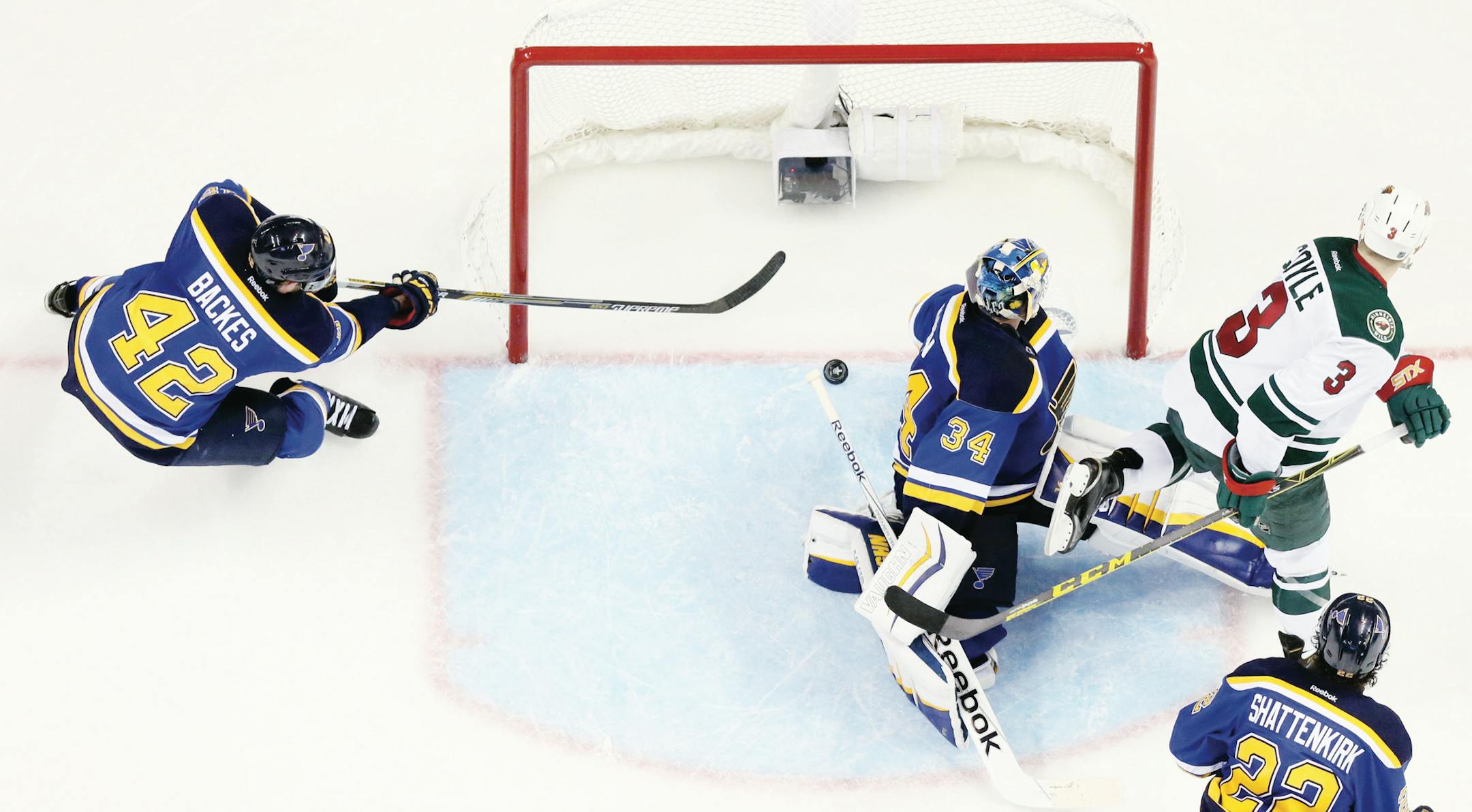 The St. Louis Blues' David Backes sweeps in behind goaltender Jake Allen to prevent the puck from crossing the goal line against the Minnesota Wild in the third period during a first-round NHL playoff game on Saturday, April 18, 2015, at the Scottrade Center in St. Louis. The Blues won, 4-1, to tie the series. (Chris Lee/St. Louis Post-Dispatch/TNS)