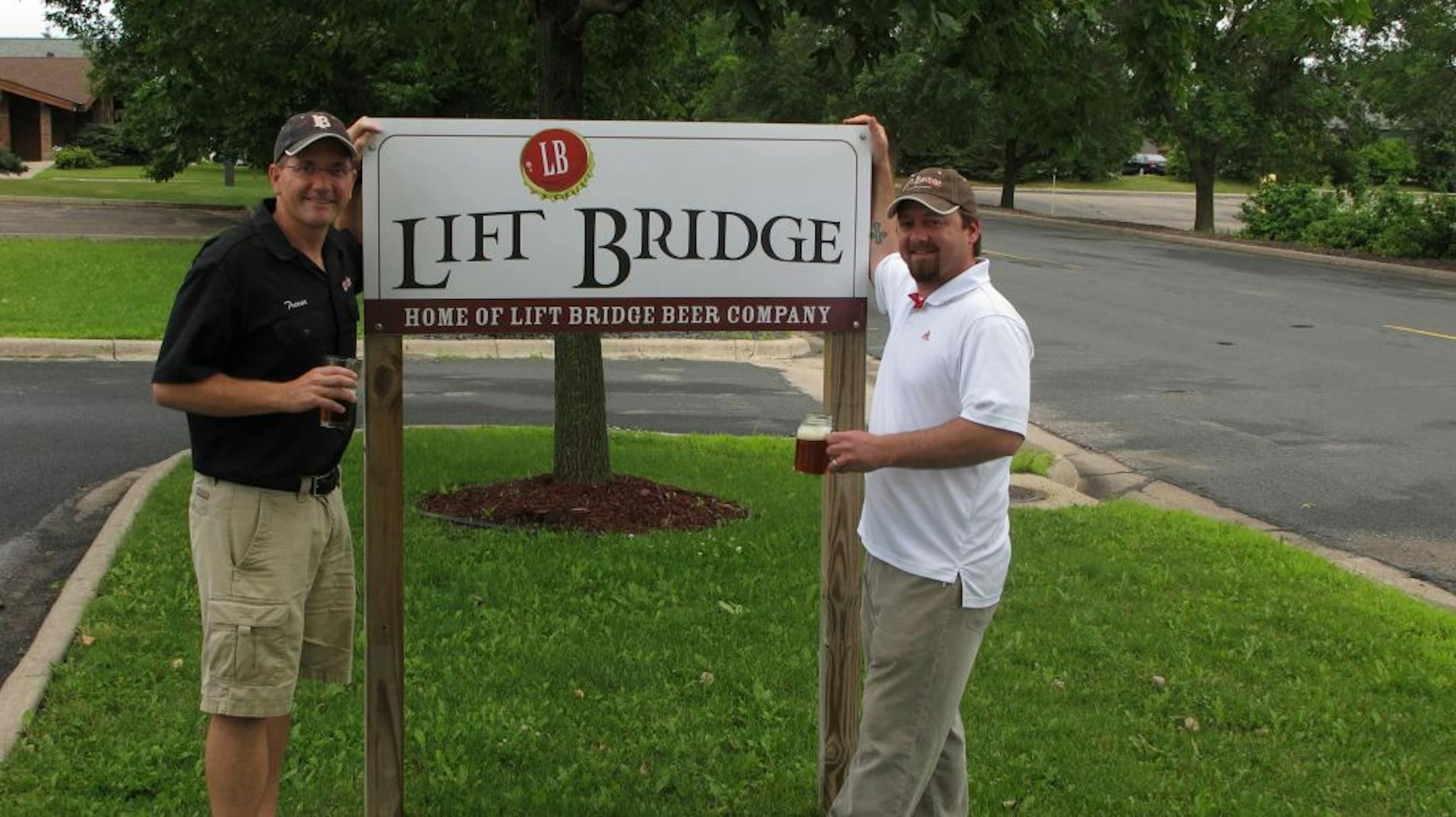 Photo by Tim HarlowBrad Glynn and Trevor Cronk stand near the sign outside the brewery at 1900 Tower Dr., stillwater
