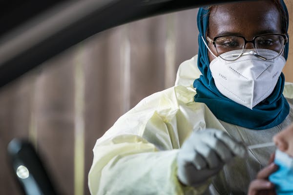 Medical assistant Samara Yusuf tested a patient in the drive-through COVID-19 testing site at North Memorial Health in Robbinsdale. ] LEILA NAVIDI •