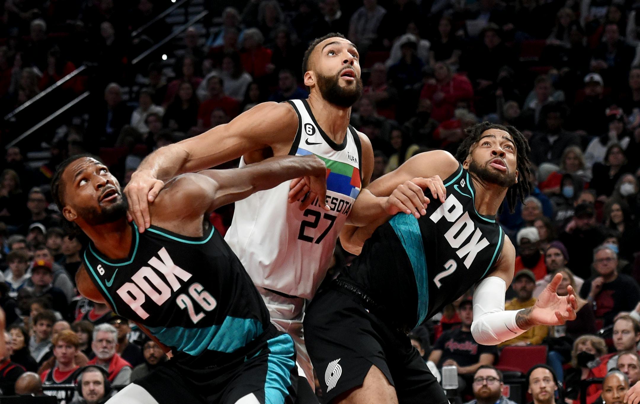 Portland Trail Blazers forward Justise Winslow, left, Minnesota Timberwolves center Rudy Gobert, center, and Trail Blazers forward Trendon Watford, right, battle for position under the basket during the first half of an NBA basketball game in Portland, Ore., Saturday, Dec.10, 2022. (AP Photo/Steve Dykes)
