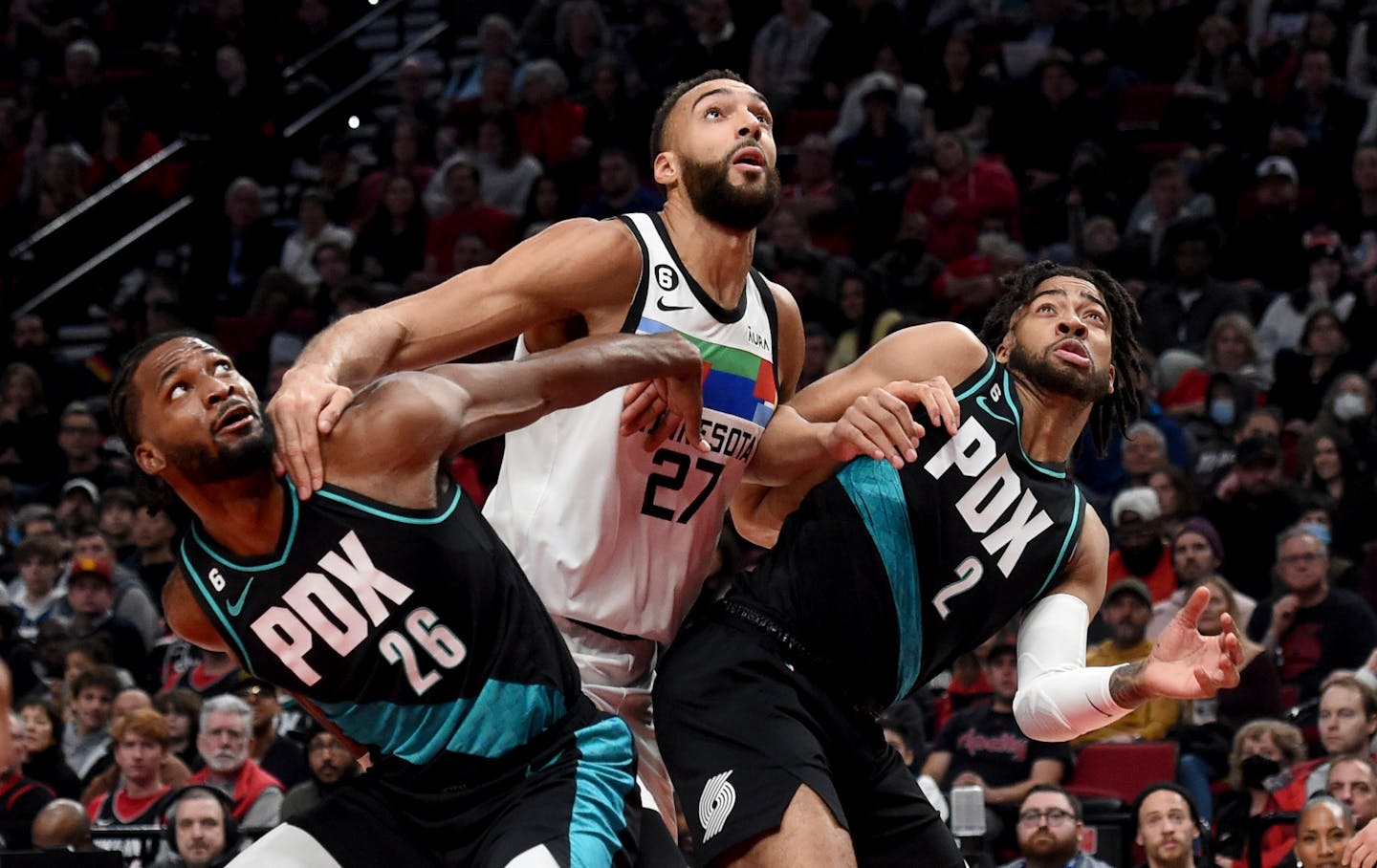 Portland Trail Blazers forward Justise Winslow, left, Minnesota Timberwolves center Rudy Gobert, center, and Trail Blazers forward Trendon Watford, right, battle for position under the basket during the first half of an NBA basketball game in Portland, Ore., Saturday, Dec.10, 2022. (AP Photo/Steve Dykes)