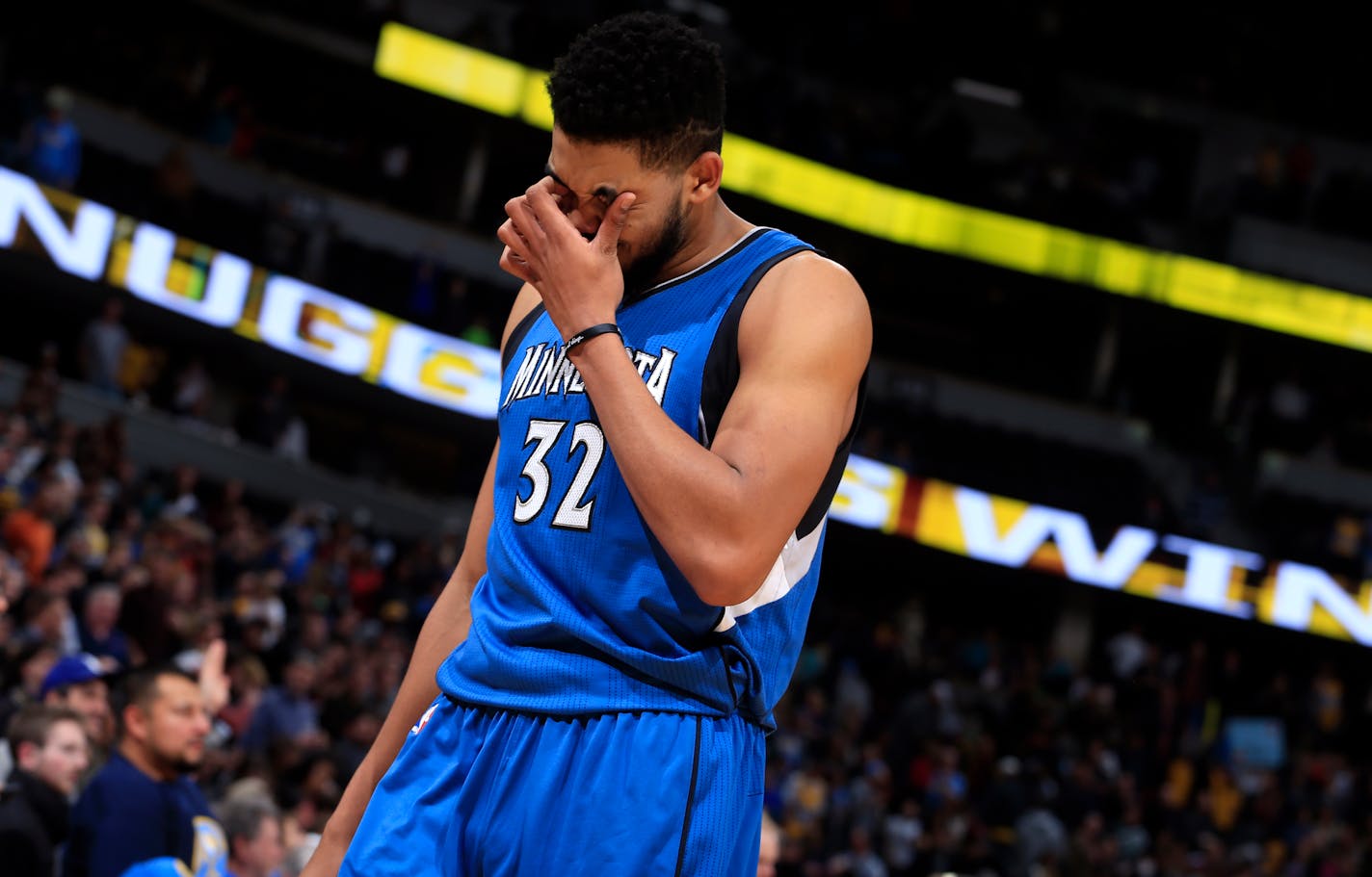 Minnesota Timberwolves center Karl-Anthony Towns (32) reacts to the team's loss to the Denver Nuggets following an NBA basketball game Wednesday, Dec. 28, 2016, in Denver. Denver beat Minnesota 105-103. (AP Photo/Jack Dempsey)