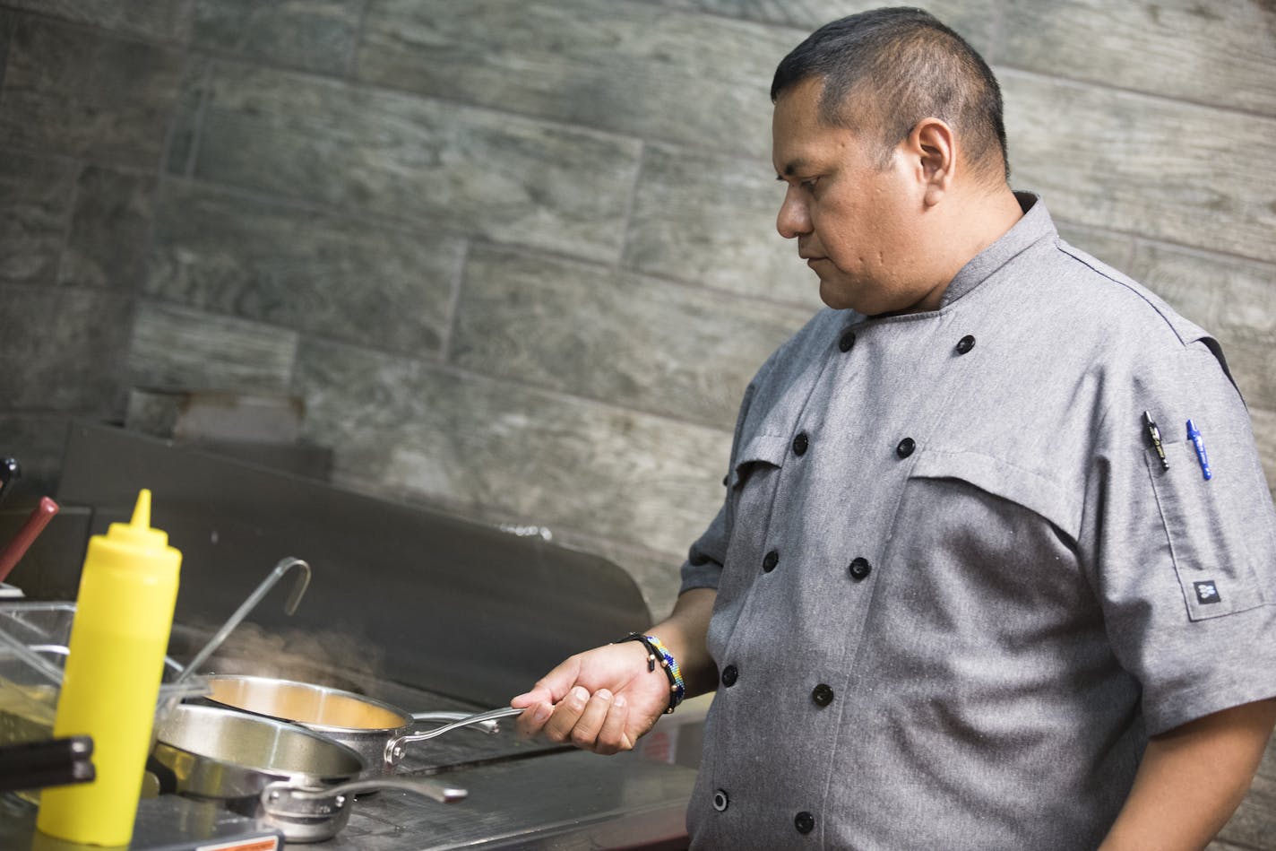 Chef Hector Ruiz prepares food in the kitchen at Costa Blanca Bistro. ] (Leila Navidi/Star Tribune) leila.navidi@startribune.com BACKGROUND INFORMATION: Food review of Costa Blanca Bistro in Minneapolis on Thursday, October 13, 2016.