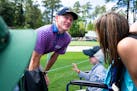 Brandt Snedeker talked to six-year-old fan Caleb Daniel during a rainy practice round before the Masters at Augusta National in Augusta, Ga., on Monda