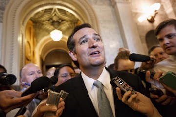 Sen. Ted Cruz, R-Texas talks to reporters as he emerges from the Senate Chamber on Capitol Hill in Washington, Wednesday, Sept 25, 2013, after his ove