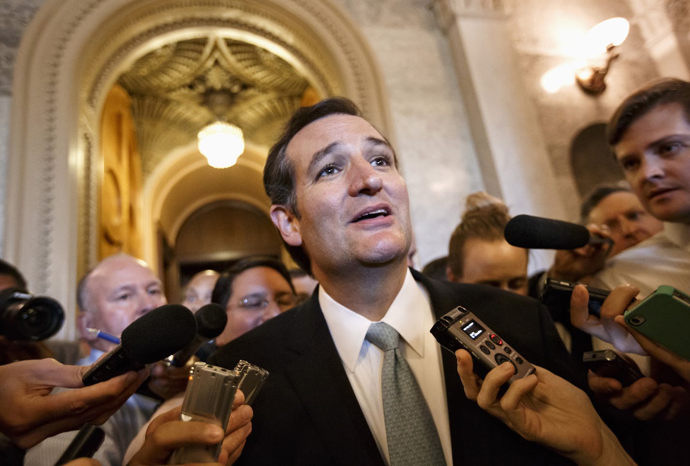 Sen. Ted Cruz, R-Texas talks to reporters as he emerges from the Senate Chamber on Capitol Hill in Washington, Wednesday, Sept 25, 2013, after his overnight crusade railing against the Affordable Care Act, popularly known as "Obamacare." Cruz ended the marathon Senate speech opposing President Barack Obama's health care law after talking for 21 hours, 19 minutes. (AP Photo/J. Scott Applewhite)