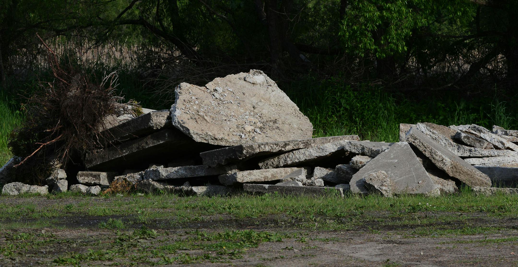 Piles of concrete sat in the area adjacent to the little league baseball diamond in Brooklyn Center, Minn., on Thursday June 4, 2015. The area has become an illegal dumpsite containing concrete and mounds of dirt. ] RACHEL WOOLF rachel.woolf@startribune.com