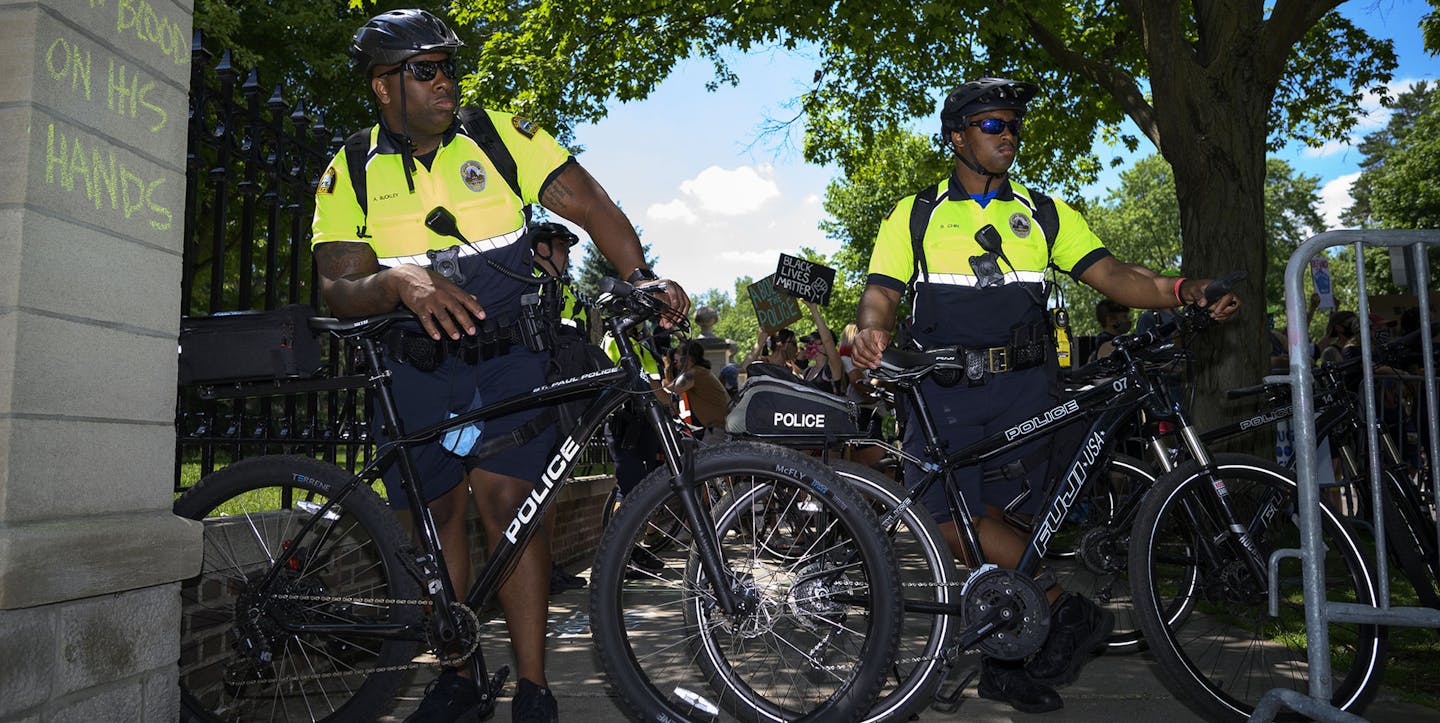 Saint Paul Police officers watched over Saturday's protest and counter protest outside the Minnesota Governor's Residence. ] aaron.lavinsky@startribune.com Pro-cop and anti-cop protesters faced off outside the Minnesota Governor's Residence on Saturday, June 27, 2020 in St. Paul, Minn. The pro-Trump group, "Bikers for 45" , organized the "Support the Police Rally" and were met, and outnumbered, by counter protesters. ORG XMIT: MIN2006271627073999