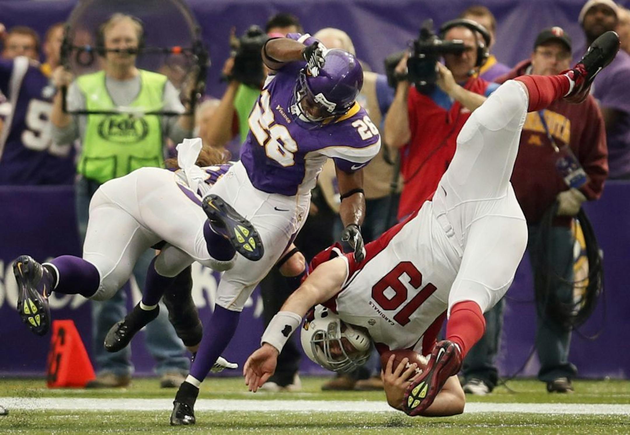 Arizona Cardinals quarterback John Skelton (19) was upended by Minnesota Vikings cornerback Antoine Winfield (26) and stop short of a first down in the third quarter at the Mall of America Field Sunday, October 21, 2012 in Minneapolis, Minnesota. The Minnesota Vikings defeated the Arizona Cardinals, 21-14.