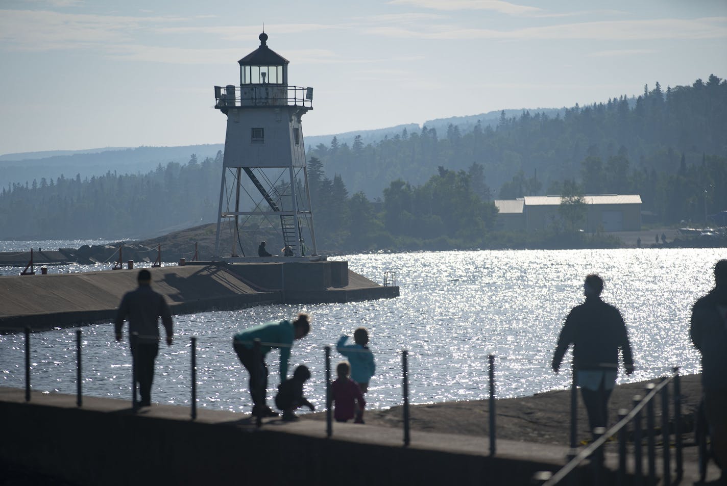 Visitors walked towards the Grand Marais Lighthouse on Tuesday afternoon. ] ALEX KORMANN • alex.kormann@startribune.com Airbnb says Grand Marais is one of the most searched destinations in the country. The flood of annual summer visitors has not be deterred by the COVID-19 pandemic as many people who had planned international travel switched to a more local getaway.