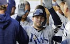 Tampa Bay Rays' Johnny Field greets teammates in the dugout after he hit a solo home run against the Seattle Mariners during the fifth inning of a bas