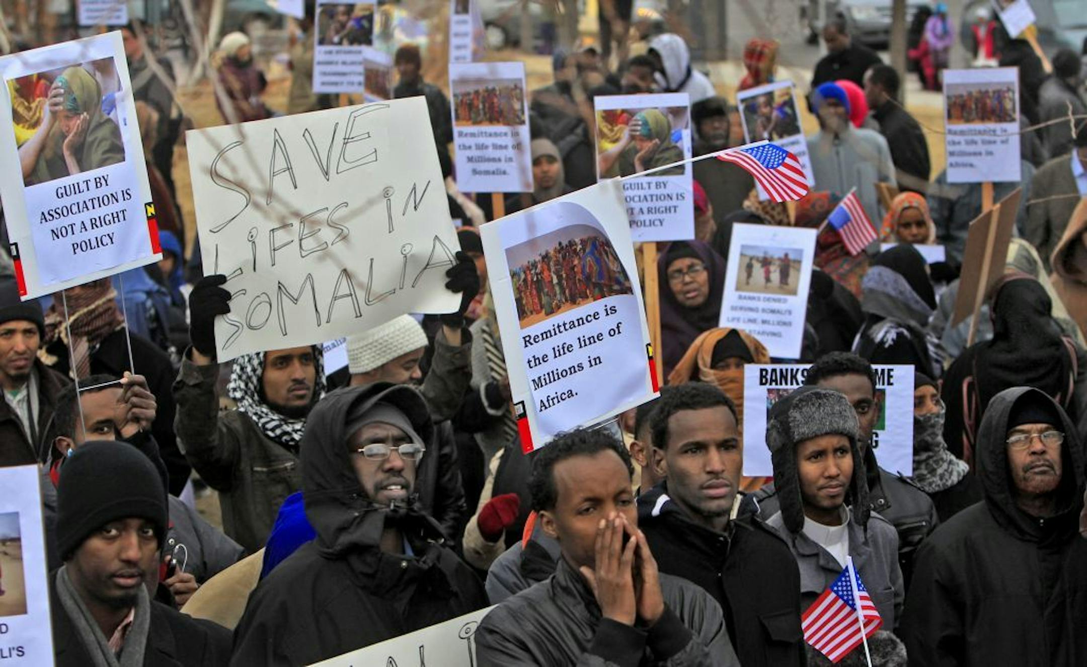 Several hundred Muslim men, women and children joined in the protest, some carrying signs and shouting to express their concerns about not being able to wire money overseas.